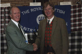 Photograph of Bruce Frazer receiving a scroll from the Hon. Peregrine of Moncrieffe