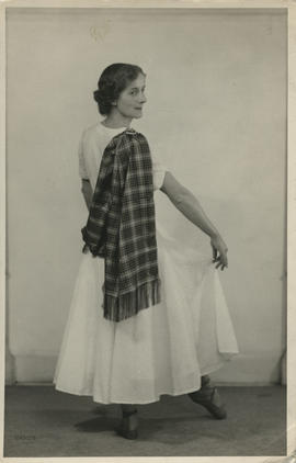 Photograph of Mina Corson demonstrating how to wear a sash