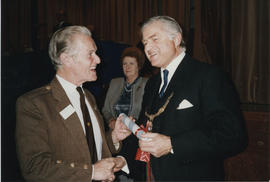 Photograph of Alastair Gillies receiving a Scroll from Lord Mansfield at the AGM in 1988.