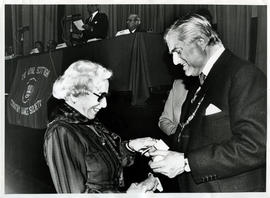 Photograph of Helene Jensen with Lord Mansfield receiving a scroll from Lord Mansfield at the AGM...