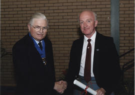 Photograph of Joe Murphy receiving a scroll awarded postumously to Alice Murphy from Lord Mansfie...