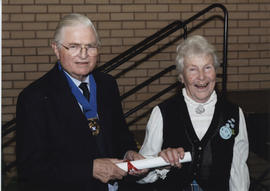 Photograph of Sally Dee receiving a scroll from Lord Mansfield at the AGM, 2004