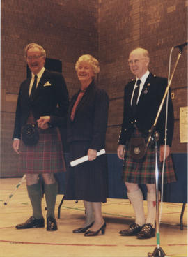 Photograph of Betty and David Grant recieving a scroll from Bill Clement