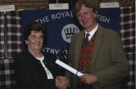 Photograph of Jessie Harper receiving a scroll from the Hion