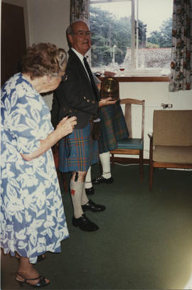 Photograph of a presentation to Dr Alastair MacFadyen by George Lawson