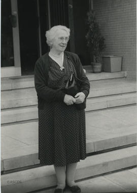 Photograph of Jean Milligan standing in front of Lumsden Hall