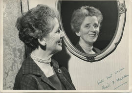 Photograph of Muriel Hadden, looking in the mirror signed 'with best wishes Muriel F Hadden