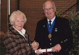 Photograph of Barbara Peel being presented with a Scroll by Alastair MacFadyen at the AGM, 2009