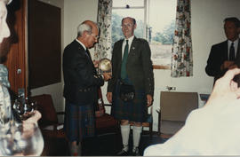 Photograph of a presentation to Dr Alastair MacFadyen by George Lawson