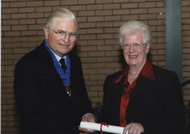 Photograph of Jennifer Wilson receiving a scroll from Lord Mansfield at the AGM, 2004