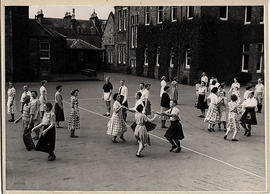 Photograph of a group dancing outside