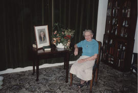 Photograph of Florence Adams with a portrait and selection of pot plants presented by Glasgow Bra...