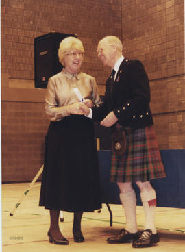 Photograph of Elma See receiving a scroll from Bill Clement