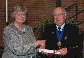 Photograph of Dorothy Hamilton being presented with a Scroll by Alastair MacFadyen at the AGM, 2009