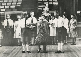 Photograph of Jeam Milligan trying out her new knees assisted by Jimmie Taylor and Bill Little