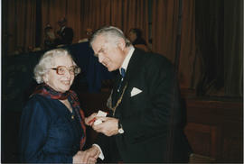 Photograph of Helene Jensen receiving a Scroll from Lord Mansfield at the AGM in 1988.