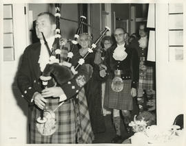 Photograph of Jean Milligan and others following a piper