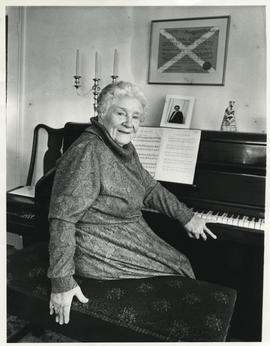 Photograph of Margaret (Peg) C. W. McAulay sitting at a piano