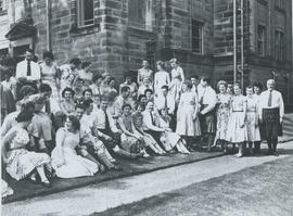 Photograph of a large group sitting outside